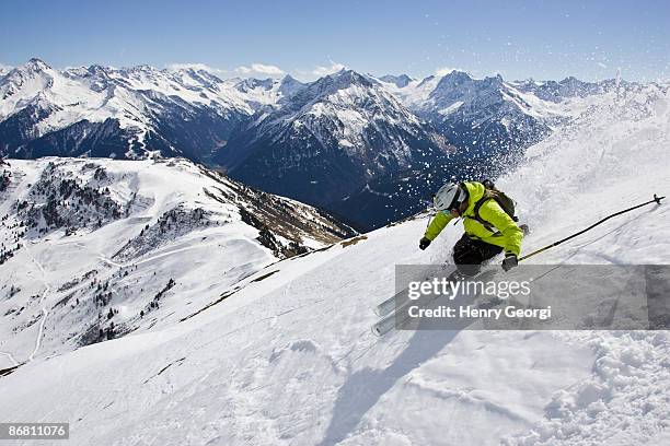 a young man skis at the mayrhofen ski resort, in the ziller valley, austria. - マイヤーホーフェン ストックフォトと画像