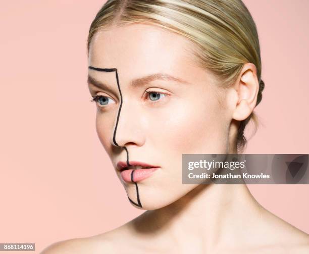 close-up of female with line drawn on face - chirurgia estetica donna foto e immagini stock