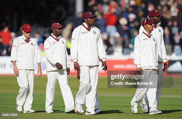 Chris Gayle of West Indies walks off with team mates after his side were defeated during day three of the 1st npower Test match between England and...