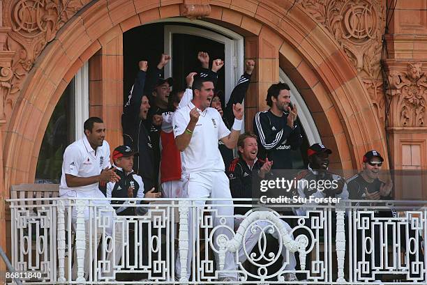 England batsman Kevin Pietersen and the rest of the team celebrate the winning runs from the players balcony during day three of the 1st npower Test...