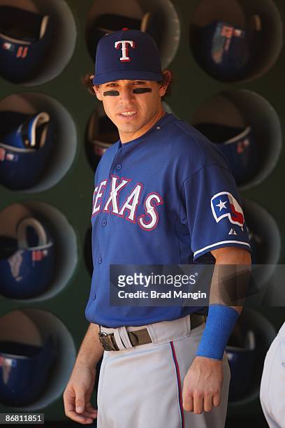 Ian Kinsler of the Texas Rangers gets ready in the dugout before the game against the Oakland Athletics at the Oakland-Alameda County Coliseum in...