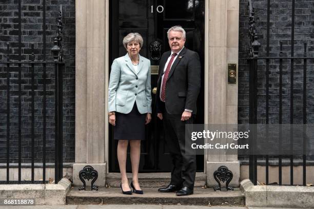 Britain's Prime Minister Theresa May greets Carwyn Jones, the First Minister of Wales, as he arrives in Downing Street on October 30, 2017 in London,...