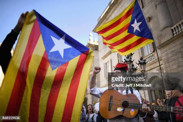 Independence supporters gather outside the Palau Catalan Regional Government Building as Catalonia returns to work following last week's decision by...
