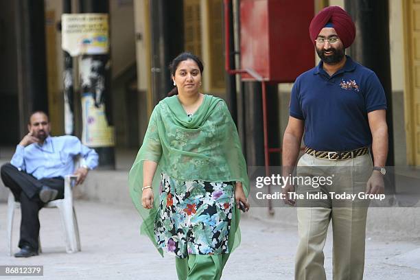 Malvinder Singh, MD of Ranbaxy laboratories exits a polling station with his wife at a school in Aurangzeb Lane after casting their votes for...