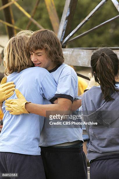 Happy Greg hugs Blaine after they complete their task in KID NATION on the CBS Television Network.