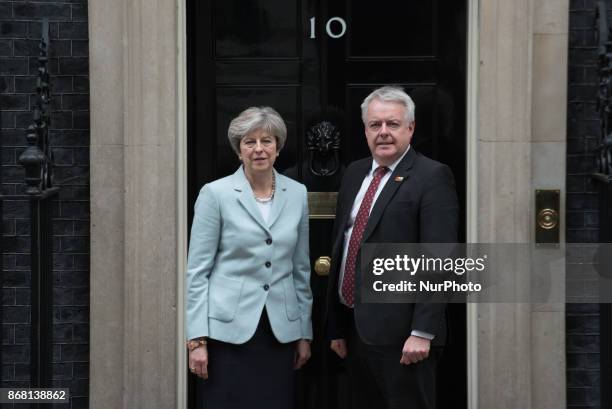 Britain's Prime Minister Theresa May greets Carwyn Jones, the First Minister of Wales, as he arrives in Downing Street on October 30, 2017 in London,...