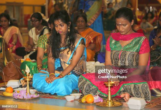 Tamil Hindu women participate in special prayers during Varalaxmi Pooja at a Tamil Hindu temple in Toronto, Ontario, Canada. Varalaxmi Pooja is...