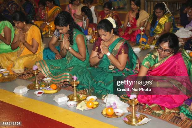 Tamil Hindu women participate in special prayers during Varalaxmi Pooja at a Tamil Hindu temple in Toronto, Ontario, Canada. Varalaxmi Pooja is...