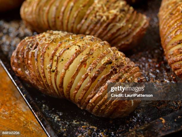 baked hasselback potatoes - potato wedges stock pictures, royalty-free photos & images