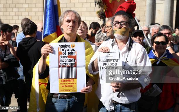Demonstrator with his mouth duck taped holds a banner in front of the 'Generalitat' palace in Barcelona on October 30, 2017. Spain enters uncharted...