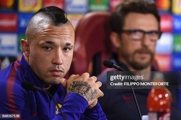 Roma's midfielder from Belgium Radja Nainggolan and AS Roma's headcoach Eusebio Di Francesco attend a press conference on the eve of the UEFA...