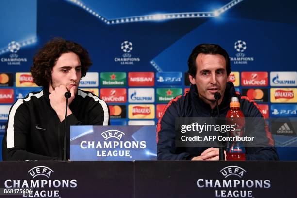 Paris Saint-Germain's Spanish headcoach Unai Emery and Paris Saint-Germain's French midfielder Adrien Rabiot give a press conference at the Parc des...