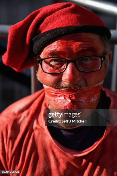 An independence supporter sits outside the Palau Catalan Regional Government Building as Catalonia returns to work following last week's decision by...