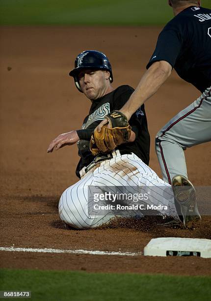 Jeremy Hermida of the Florida Marlins slides into third base during a game against the Atlanta Braves at Dolphin Stadium on May 6, 2009 in Miami,...