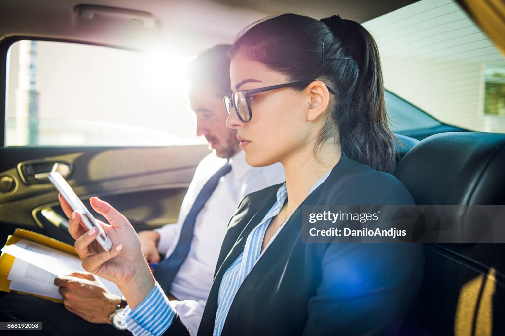 Business people working in the car