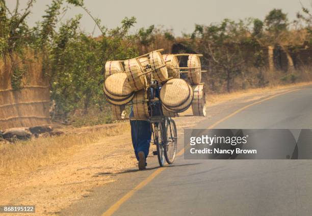 traditional african man & traditional transportation on road in malawi. - lilongwe stock-fotos und bilder