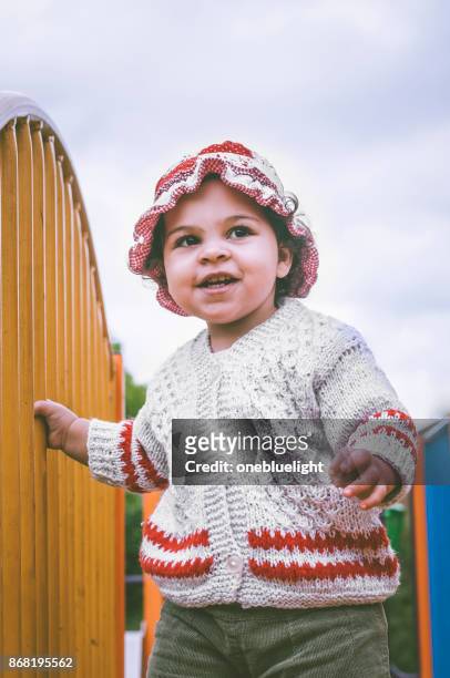 baby girl having fun in playground. - onebluelight stock pictures, royalty-free photos & images