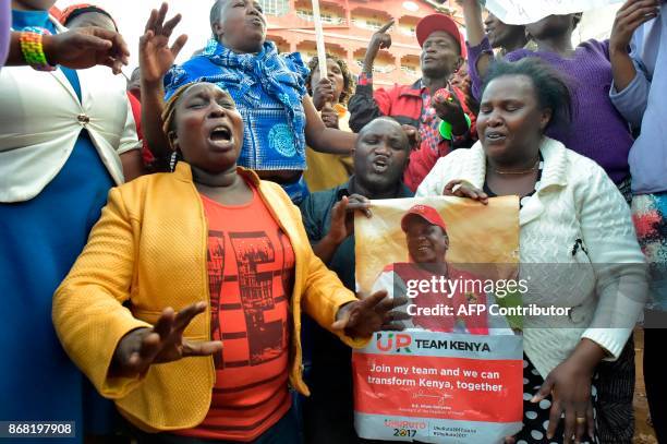 Supporters of Kenya's President Uhuru Kenyatta celebrate after Kenyatta was declared the winner following presidential re-election results by Kenya's...