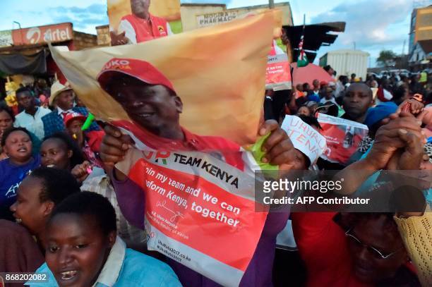 Supporters of Kenya's President Uhuru Kenyatta celebrate after Kenyatta was declared the winner following presidential re-election results by Kenya's...