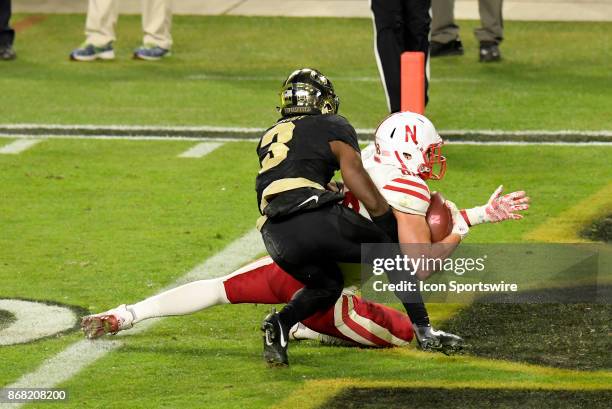 Nebraska Cornhuskers tight end Tyler Hoppes steps into the end zone and is immediately hit by Purdue Boilermakers cornerback Kamal Hardy during the...