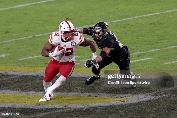 Nebraska Cornhuskers running back Devine Ozigbo slips a tackle at mid-field during the Big Ten conference game between the Purdue Boilermakers and...