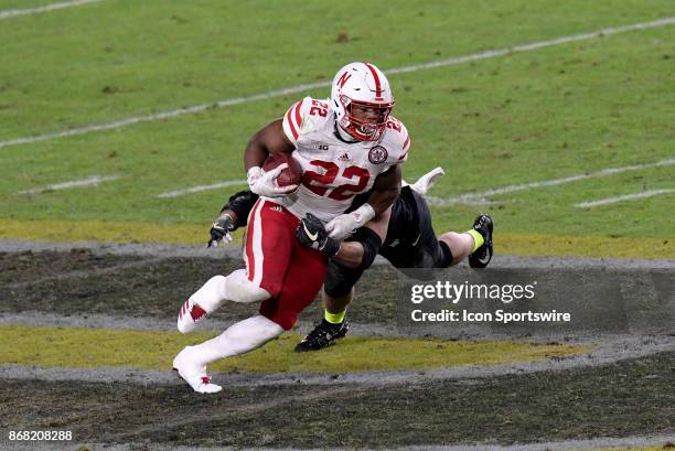 Nebraska Cornhuskers running back Devine Ozigbo slips a tackle at mid-field during the Big Ten conference game between the Purdue Boilermakers and...