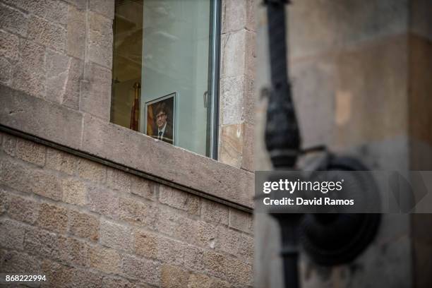 Portrait of the deposed President of Catalonia Carles Puigdemont hangs on a wall inside the Catalan Government building, Palau de la Generalitat, on...