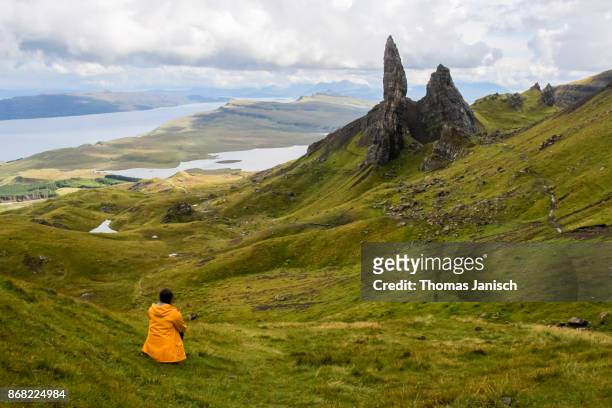 girl looking at the old man of storr, scotland - old man of storr stock pictures, royalty-free photos & images