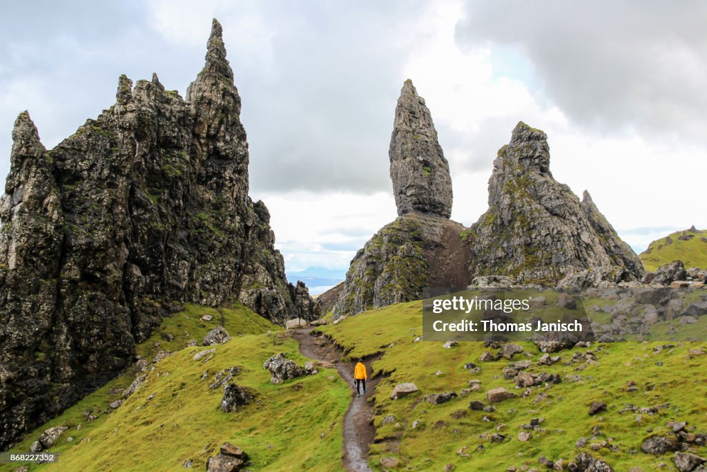 Girl hiking towards The Old Man of Storr, Scotland
