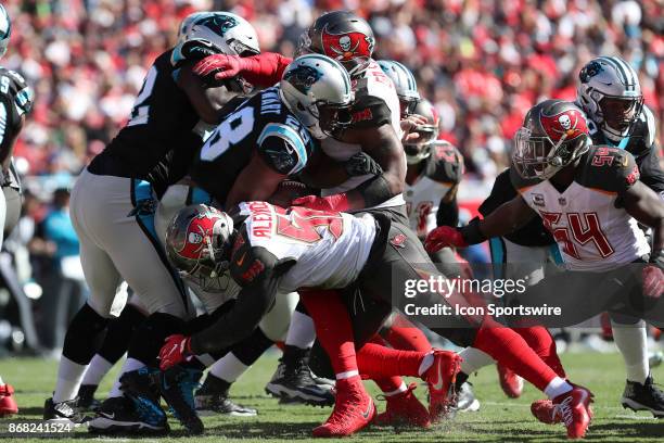 Carolina Panthers running back Jonathan Stewart is tackled by Tampa Bay Buccaneers defensive end William Gholston and Tampa Bay Buccaneers middle...