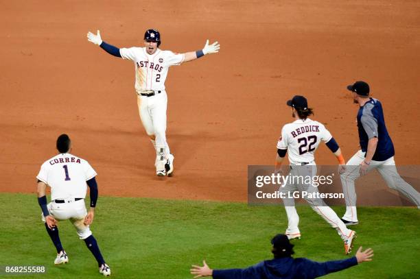 Alex Bregman of the Houston Astros is mobbed by teammates after hitting the game-winning RBI single in the 10th inning during Game 5 of the 2017...