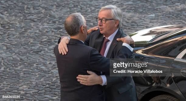 Portuguese President Marcelo Rebelo de Sousa embraces the President of the European Commission Jean-Claude Juncker at his arrival in Belem Palace on...
