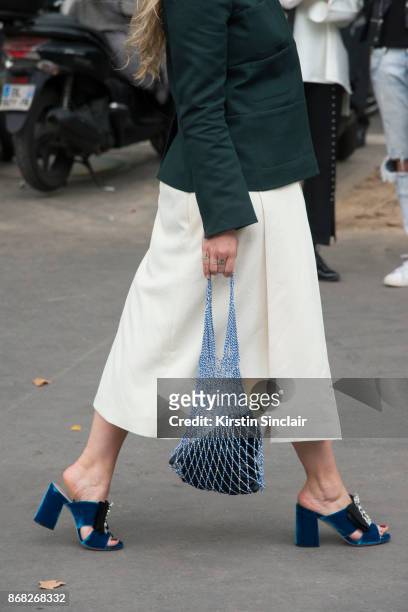 Fashion stylist and consultant Kate Foley Osterweis wears a Carven jacket and skirt, Miu Miu shoes and a Celine bag day 3 of Paris Womens Fashion...