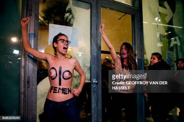 Members of feminist activist group Femen gesture during a demonstration on October 30 after being thrown out of the Cinematheque Francaise film...