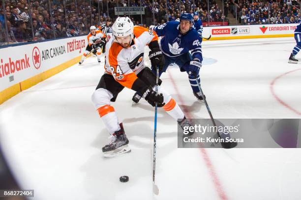Philadelphia Flyers right wing Matt Read battles for the puck against Toronto Maple Leafs defenseman Roman Polak during the first period at the Air...