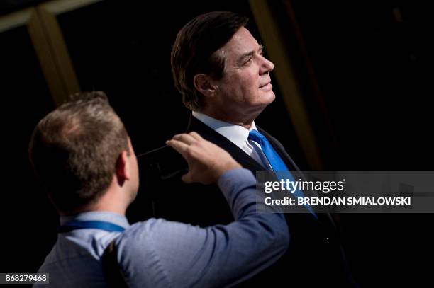 Paul Manafort, former campaign manager for US President Donald Trump, leaves the E. Barrett Prettyman United States Court House after being charged...