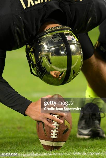 The reflection of the goalpost is seen in the helmet of Purdue Boilermakers long snapper Ben Makowski during the Big Ten conference game between the...