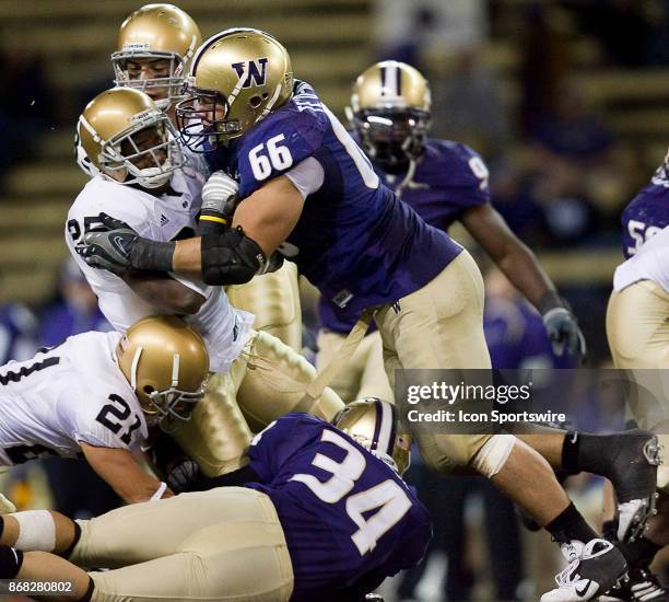 University of Washington defensive end Daniel Te'o-Nesheim takes down University of Notre Dame running back Jonas Gray during the second half of play...