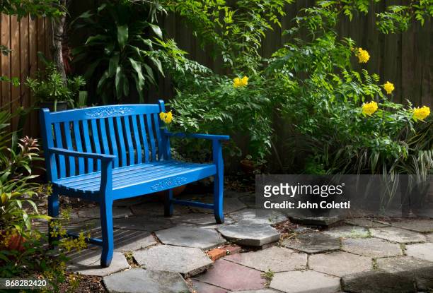 backyard garden, saint petersburg, florida - man on bench stock-fotos und bilder