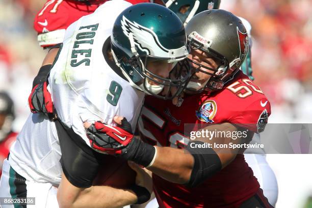 Nick Foles of the Eagles is sacked and brought down hard by Buccaneer defensive end Daniel Te'o-Nesheim during the NFL regular season game between...