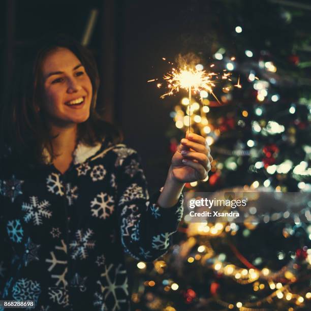 woman holding sparkler, celebrating new year's eve - pj sparks stock pictures, royalty-free photos & images