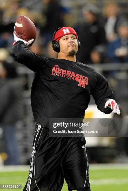 Nebraska Cornhuskers cornerbacks coach Donte Williams throws a pass during warm ups for the Big Ten conference game between the Purdue Boilermakers...