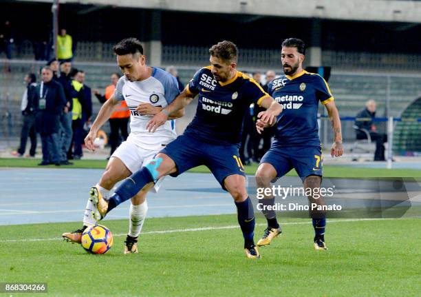 Alessio Cerci of Hellas Verona FC competes with Yuto Nagatomo of FC Internazionale during the Serie A match between Hellas Verona FC and FC...