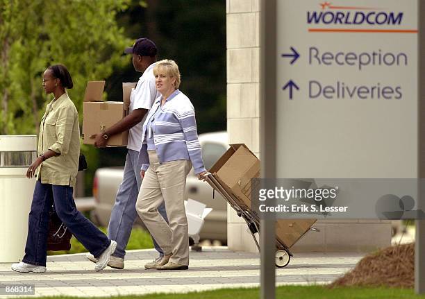 Employees leave the WorldCom building June 28, 2002 in Alpharetta, Georgia. About 17,000 workers at the financially troubled company are slated for...