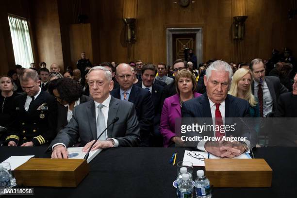 Secretary of Defense James Mattis and U.S. Secretary of State Rex Tillerson take their seats as they arrive for a Senate Foreign Relations Committee...