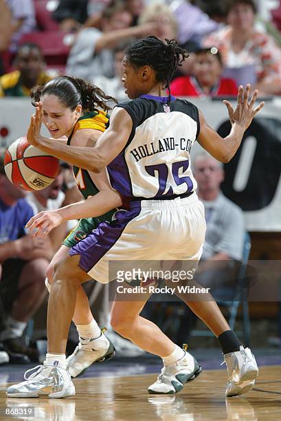 Sue Bird of the Seattle Storm is defended by Kedra Holland-Corn of the Sacramento Monarchs during the game on June 20, 2002 at Arco Arena in...