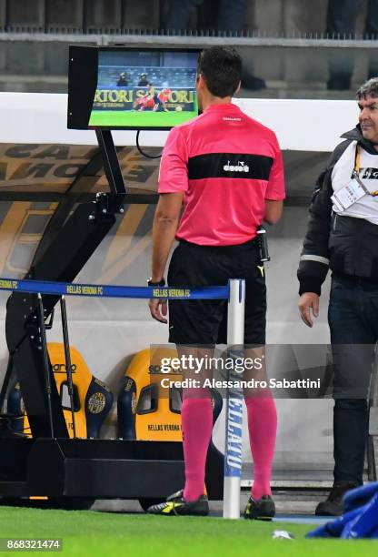 Referee Claudio Gavillucci examines the new system VAR during the Serie A match between Hellas Verona FC and FC Internazionale at Stadio Marc'Antonio...