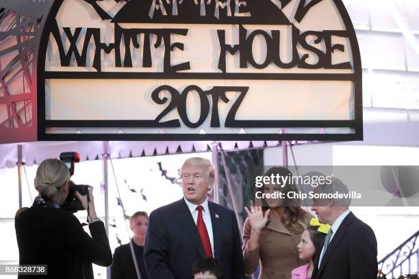 President Donald Trump and first lady Melania Trump pose for photographs with Attorney General Jeff Sessions and the children he was accompanying...