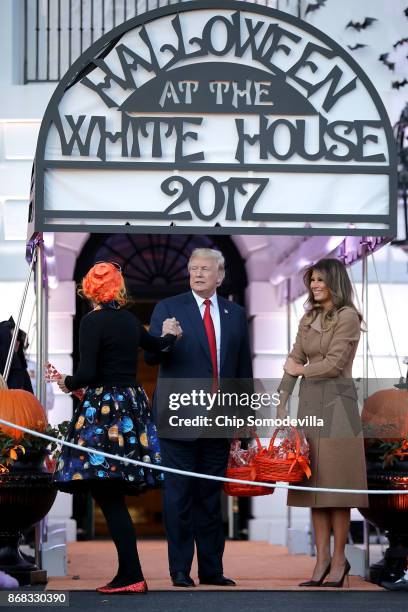 President Donald Trump and first lady Melania Trump greet Education Secretary Betsy DeVos, who was dressed as Ms. Frizzle from 'The Magic Schoolbus'...