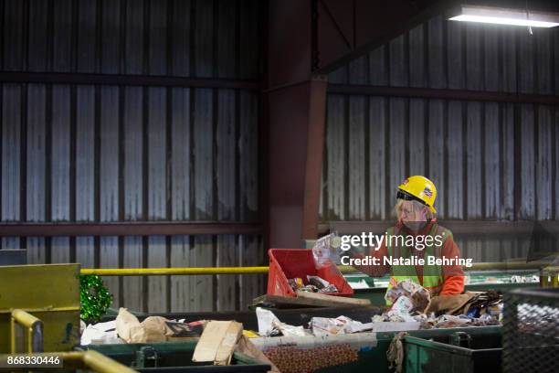 Workers sort paper and plastic waste at Far West Recycling October 30, 2017 in Hillsboro, Oregon. China is sharply restricting imports on recycled...